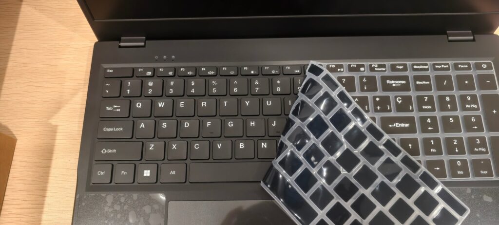 Transparent Spanish keyboard film being applied over the standard US keyboard of a P1 laptop